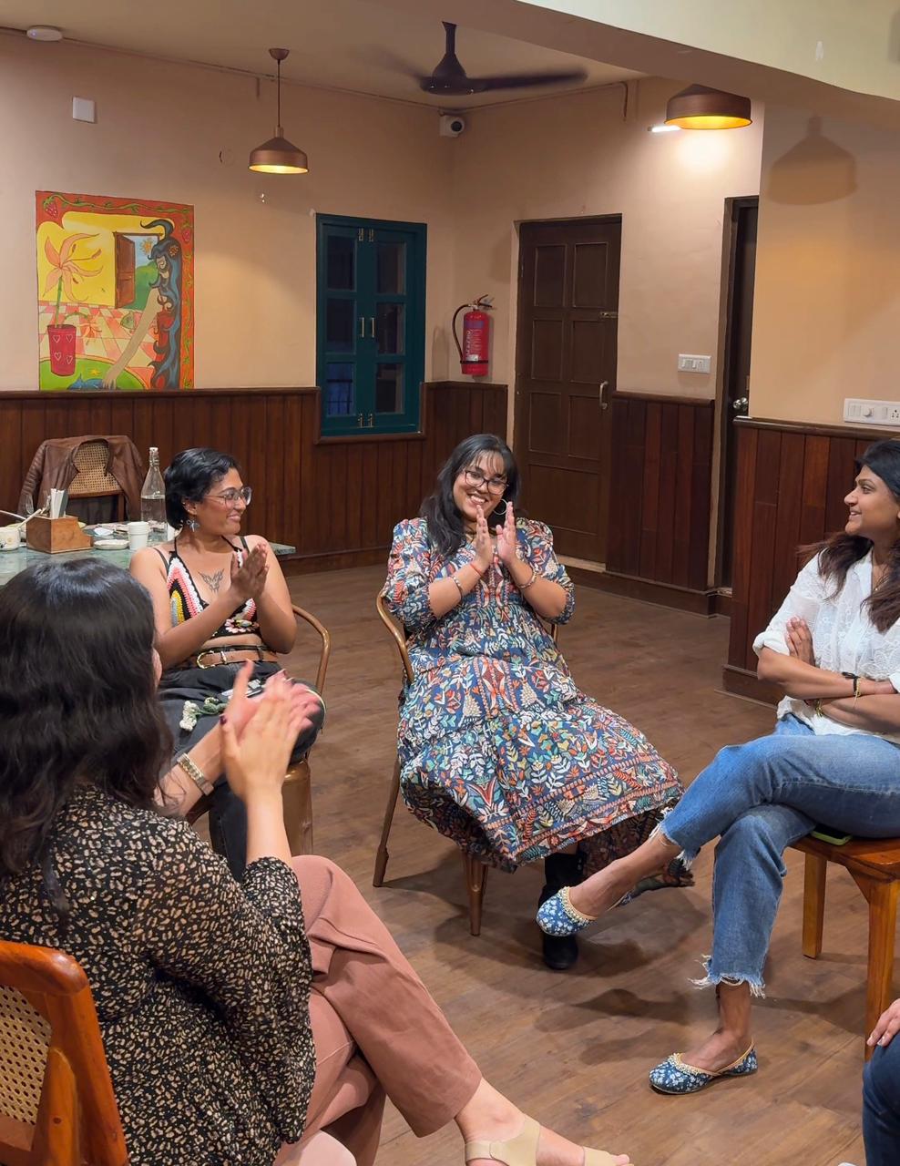 A mentor guiding a small group through a coaching conversation